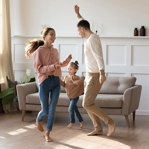 Family dancing at home | New York Carpets & Flooring