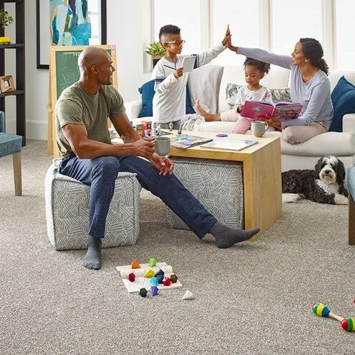 Family enjoying sitting in living room | New York Carpets & Flooring